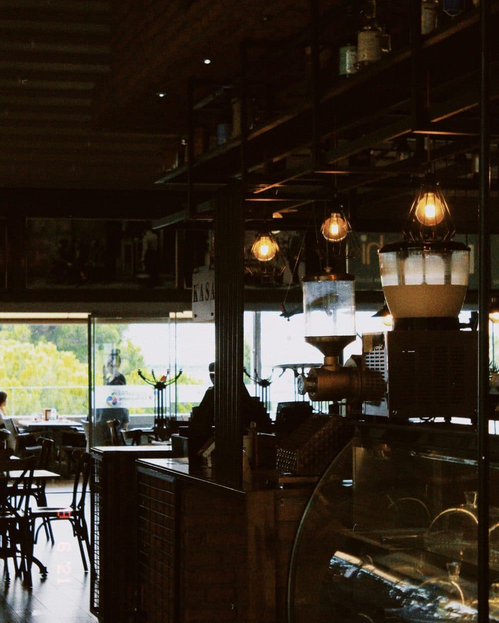 Warm café interior with hanging lights and timber tables