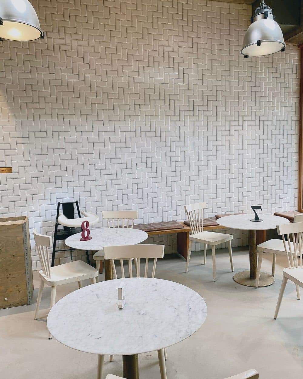 Bright airy café with marble tables and pendant lights